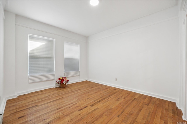 empty room with hardwood / wood-style flooring