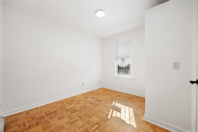 spare room with light parquet floors and a baseboard radiator