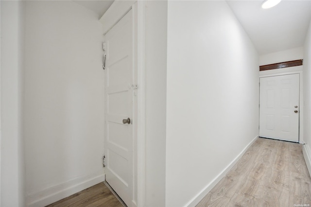 hallway with light hardwood / wood-style floors