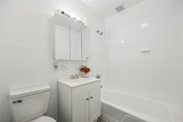 full bathroom featuring toilet, tile walls, shower / bathtub combination, and vanity