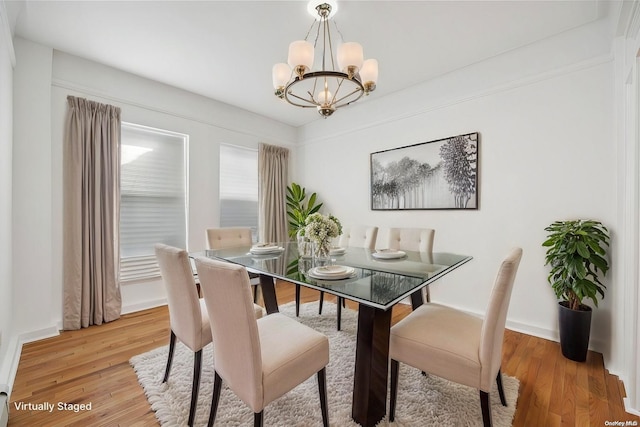 dining room featuring a notable chandelier and hardwood / wood-style floors