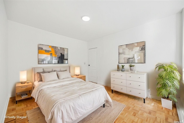 bedroom with light parquet floors and a closet