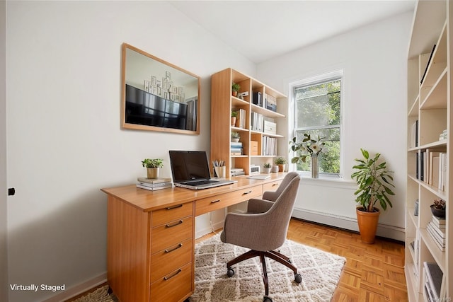 office space with light parquet floors, a wealth of natural light, and baseboard heating