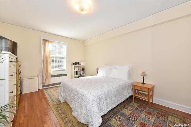 bedroom featuring radiator and dark wood-type flooring