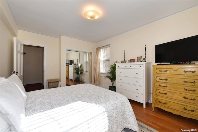 bedroom with a closet and dark hardwood / wood-style floors