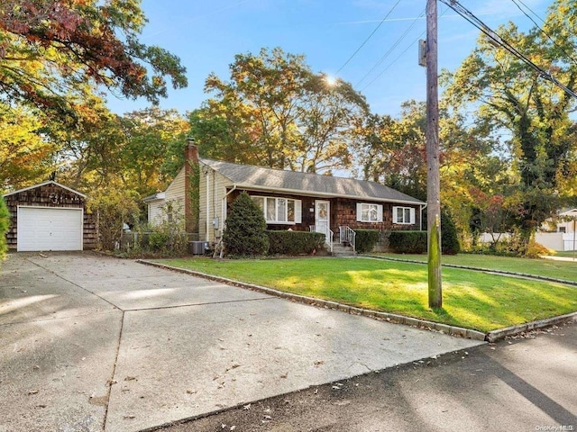 view of front facade featuring cooling unit, an outbuilding, a front lawn, and a garage