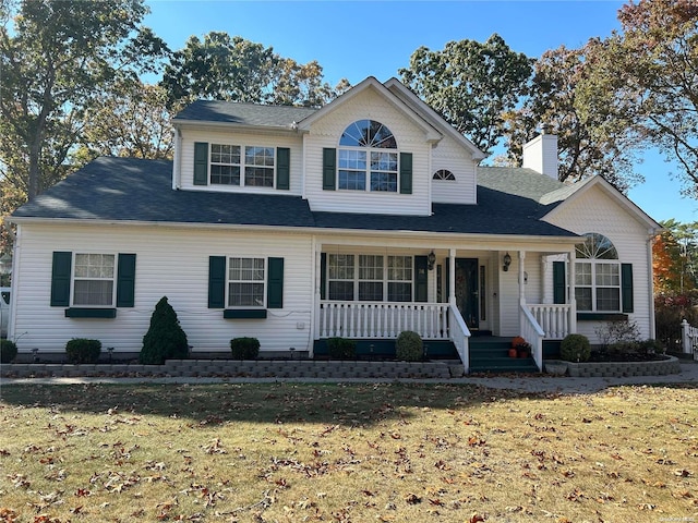 front of property featuring a porch and a front yard