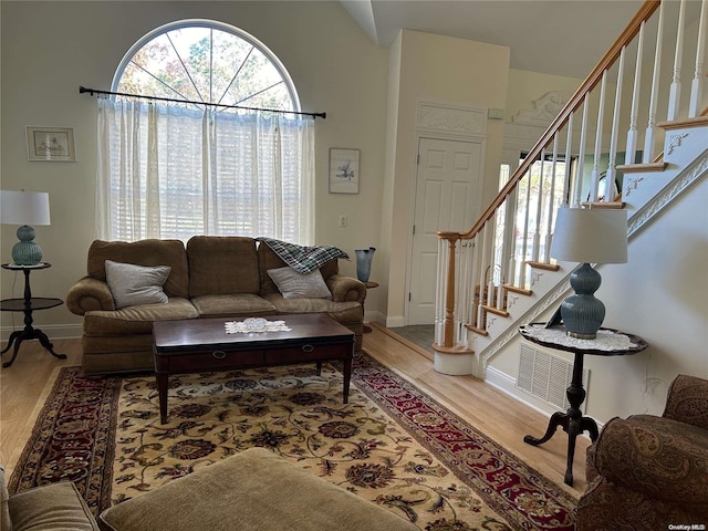 living room with wood-type flooring and lofted ceiling