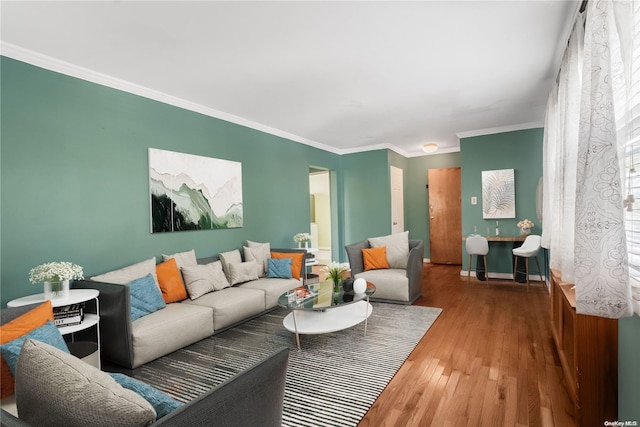 living room with hardwood / wood-style flooring and crown molding