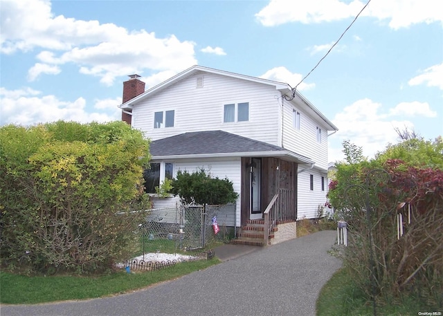 4 Quail Rd, Mastic Beach, NY 11951 - view of front of home featuring a chimney and entry steps