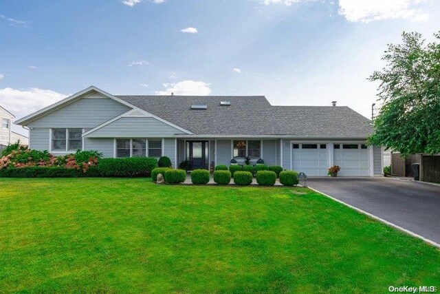 112 Lucinda Dr, Babylon, NY 11702 - view of front facade featuring asphalt driveway, a front lawn, a garage, and a shingled roof