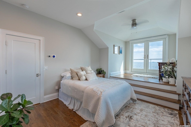 bedroom featuring french doors, vaulted ceiling, light hardwood / wood-style flooring, and ceiling fan