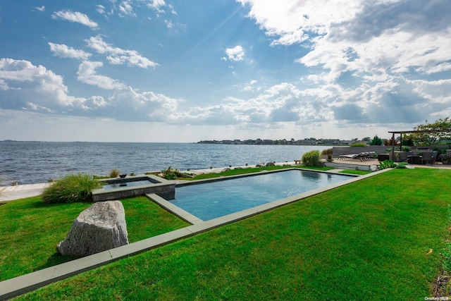 exterior space with an in ground hot tub, a water view, and a lawn