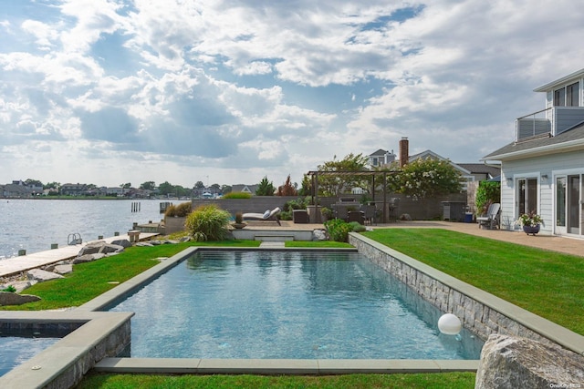 view of swimming pool with a yard, a patio, and a water view