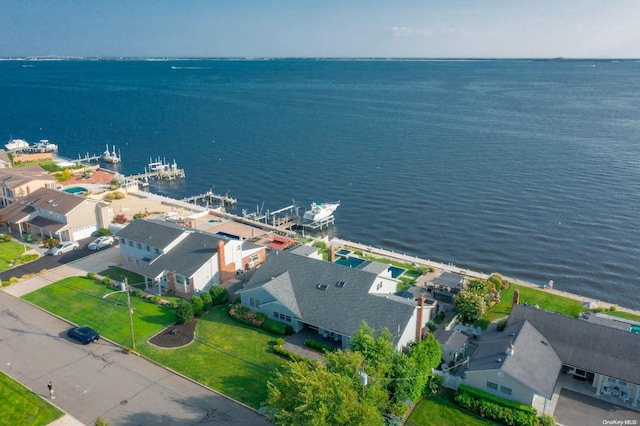 drone / aerial view featuring a water view and a residential view