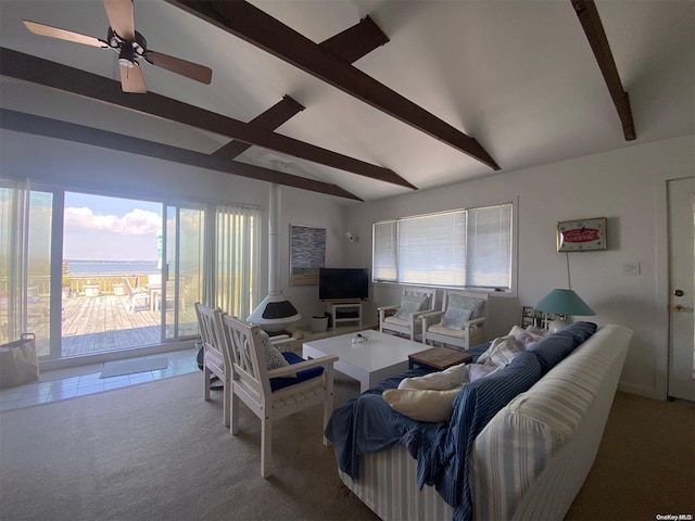 living room featuring vaulted ceiling with beams, ceiling fan, and carpet floors