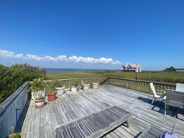 wooden terrace featuring a water view