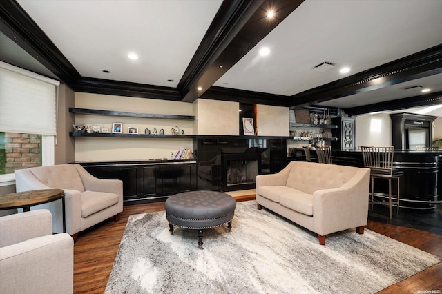 interior space featuring hardwood / wood-style flooring, beam ceiling, ornamental molding, and indoor bar