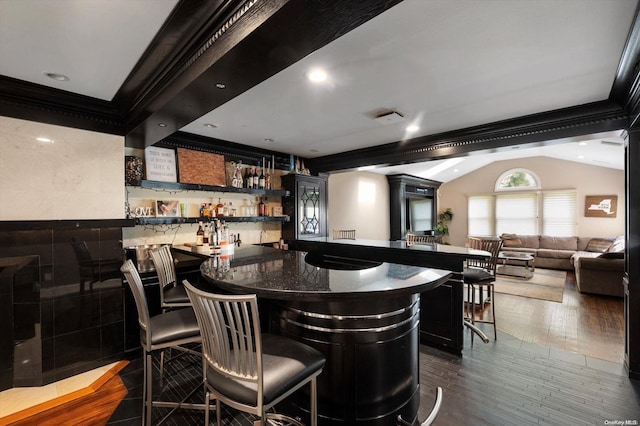 bar with dark hardwood / wood-style floors, crown molding, and vaulted ceiling