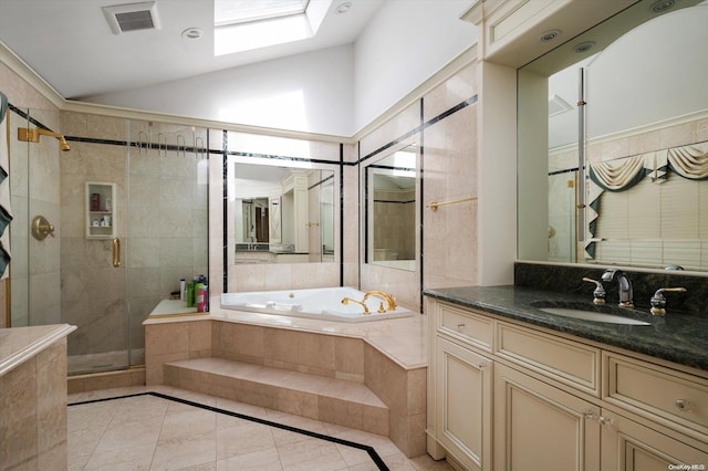 bathroom with lofted ceiling with skylight, tile patterned flooring, vanity, and independent shower and bath