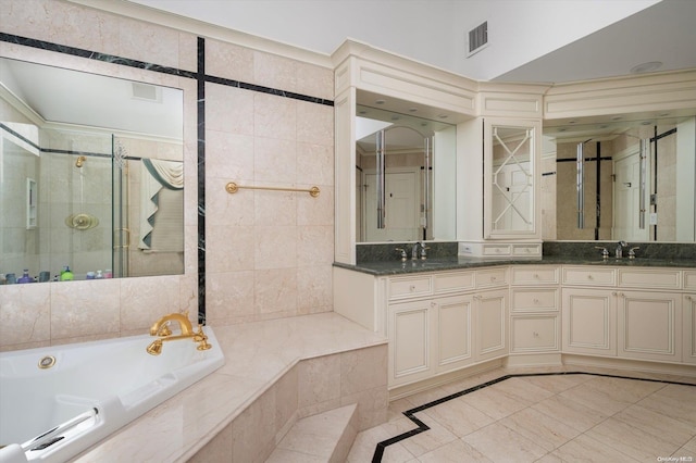 bathroom with tile patterned floors, vanity, and independent shower and bath