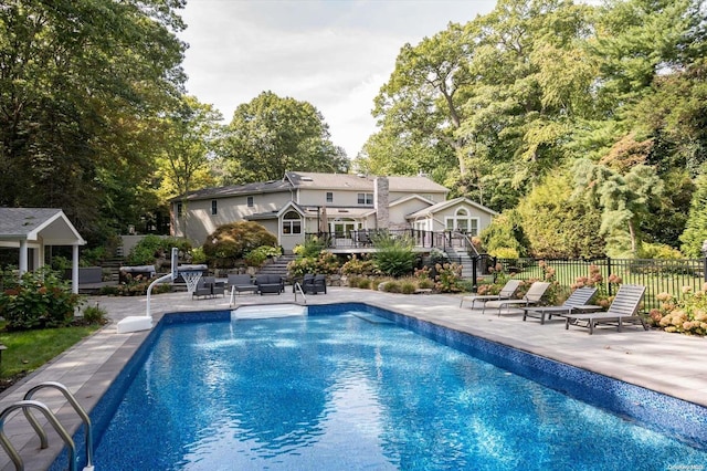 view of swimming pool with a patio and a deck