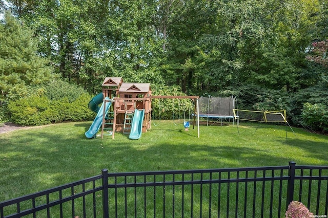 view of play area with a trampoline and a lawn