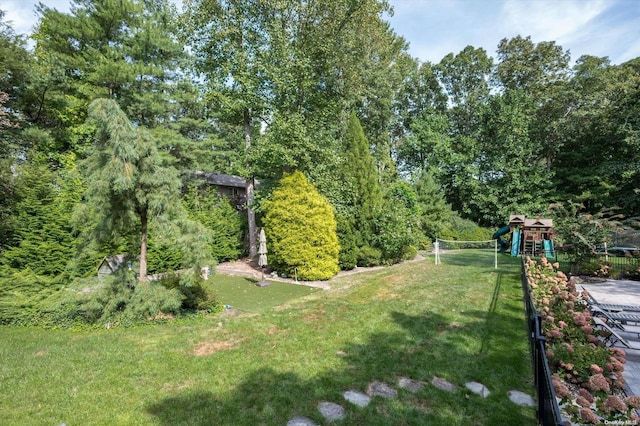 view of home's community with a playground and a yard