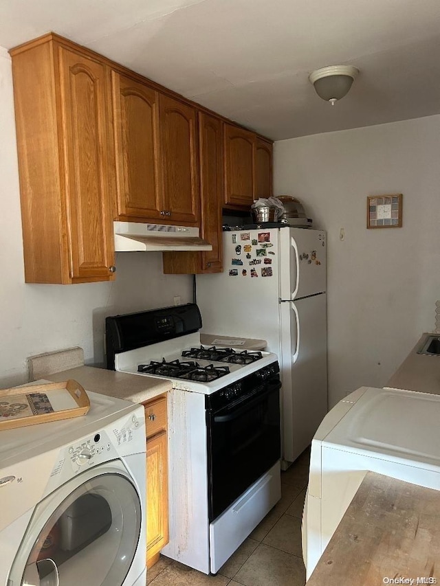 kitchen featuring washer / clothes dryer, light tile patterned flooring, and white range with gas cooktop