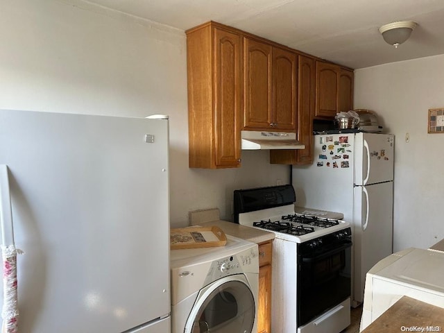 kitchen with washer / dryer and white appliances