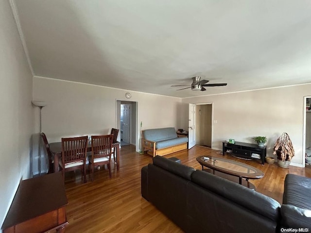 living room with wood-type flooring and ceiling fan