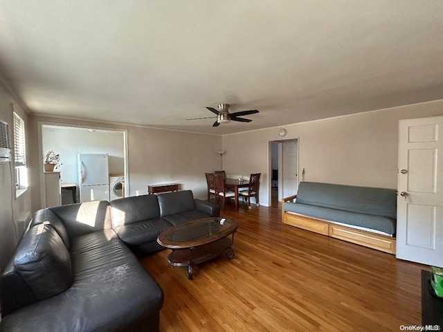 living room with ceiling fan, washer / dryer, and wood-type flooring