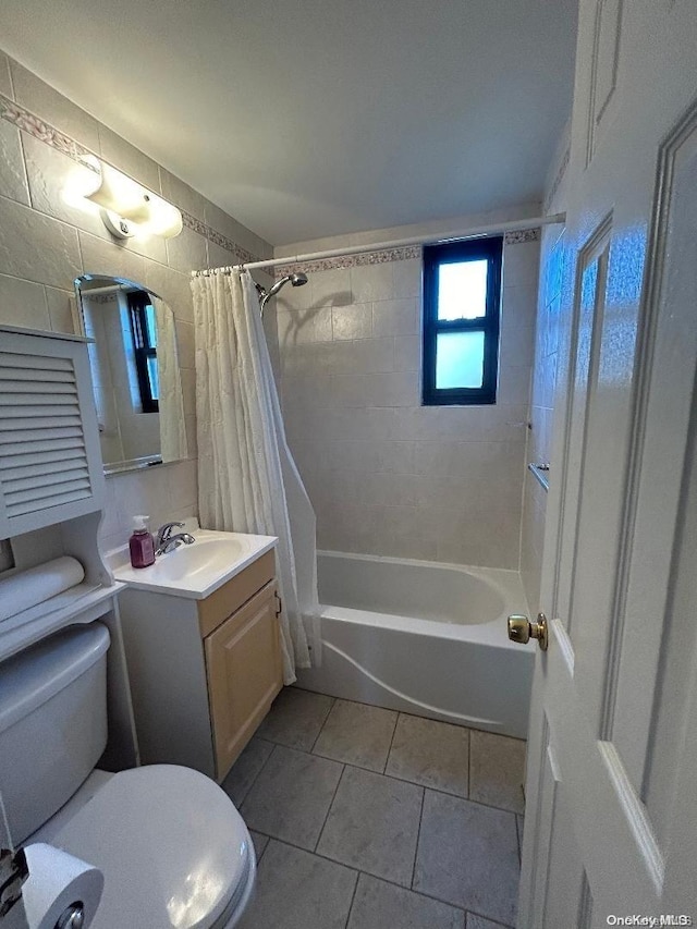 full bathroom featuring tile patterned floors, vanity, toilet, and shower / bathtub combination with curtain