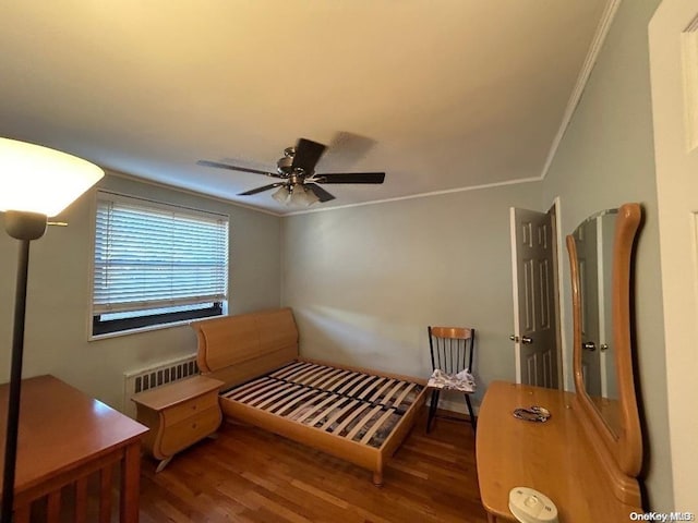 living area featuring radiator, ceiling fan, ornamental molding, and hardwood / wood-style flooring