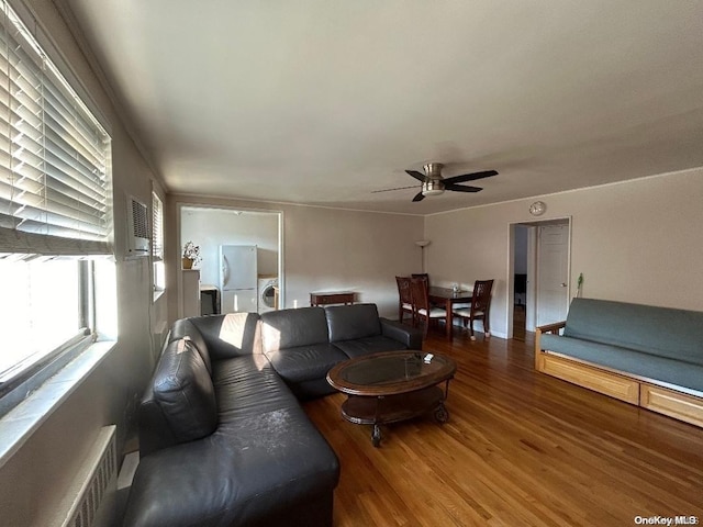 living room featuring ceiling fan, wood-type flooring, and washer / clothes dryer