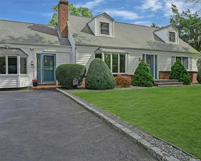 cape cod-style house with a front lawn