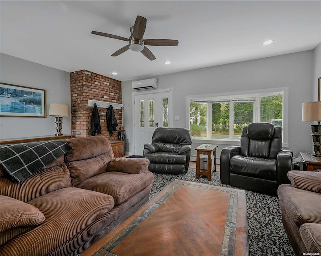 living room featuring an AC wall unit and ceiling fan