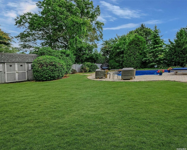 view of yard featuring a shed and a patio