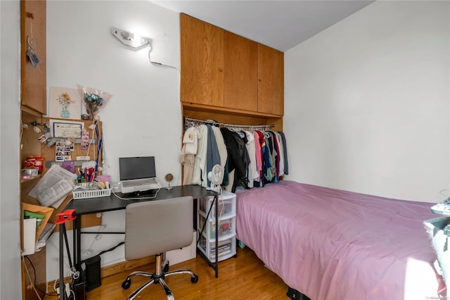 bedroom featuring a closet and light hardwood / wood-style flooring