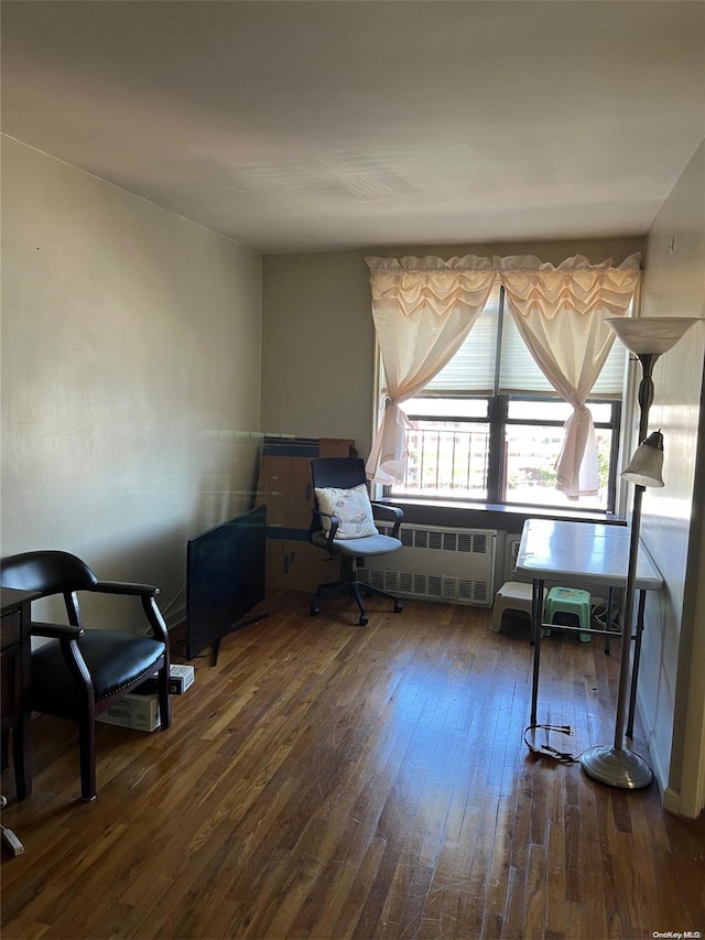 office space with radiator and dark hardwood / wood-style flooring