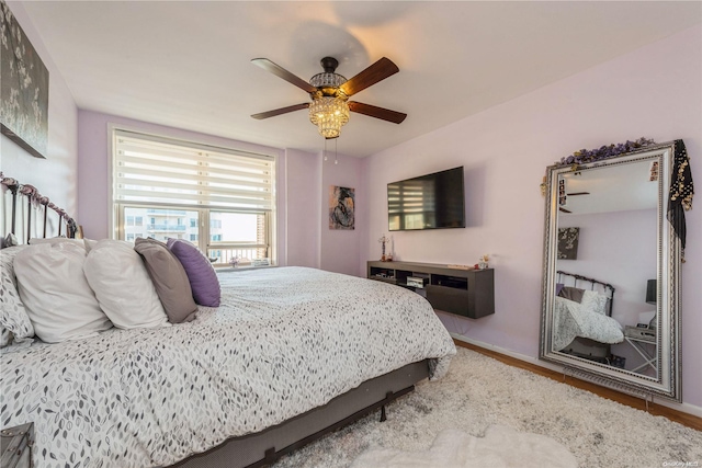 bedroom featuring ceiling fan and wood-type flooring