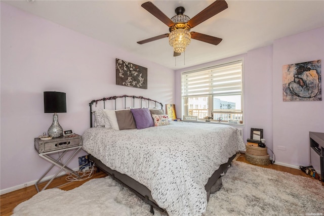 bedroom featuring ceiling fan and hardwood / wood-style floors