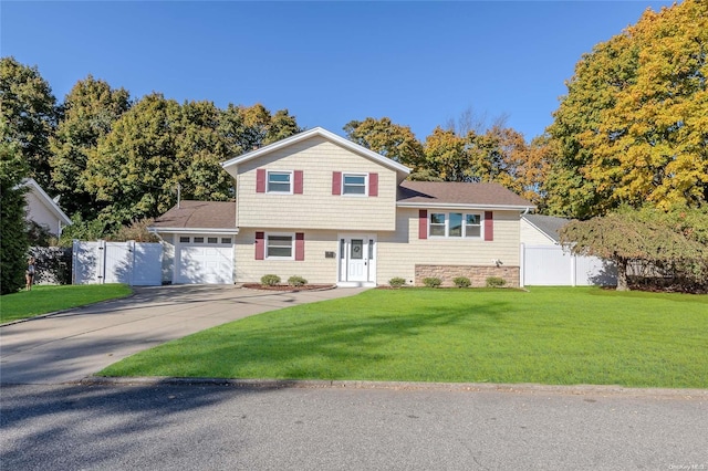 split level home with a garage and a front lawn