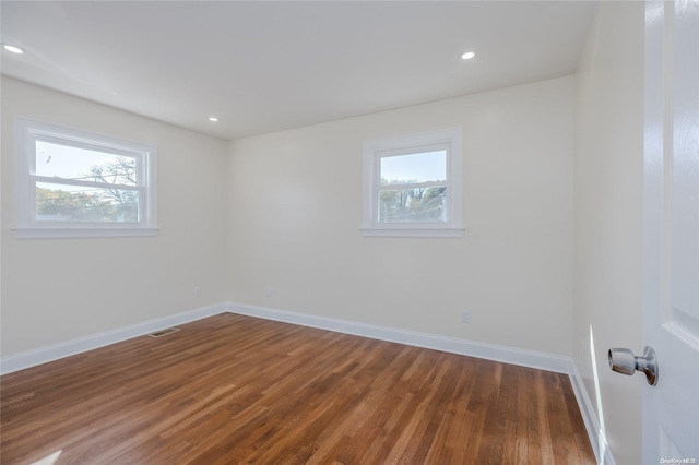 unfurnished room featuring dark hardwood / wood-style flooring