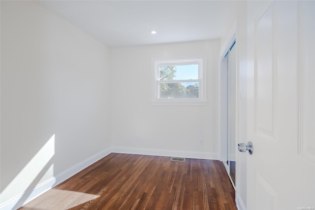 unfurnished room featuring dark hardwood / wood-style flooring