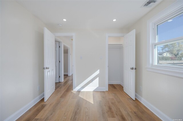 unfurnished bedroom featuring a closet and light hardwood / wood-style floors