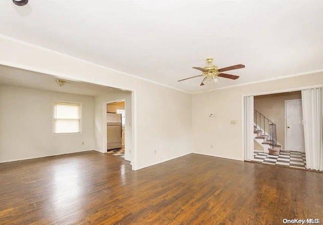 empty room featuring dark hardwood / wood-style floors, ceiling fan, and crown molding