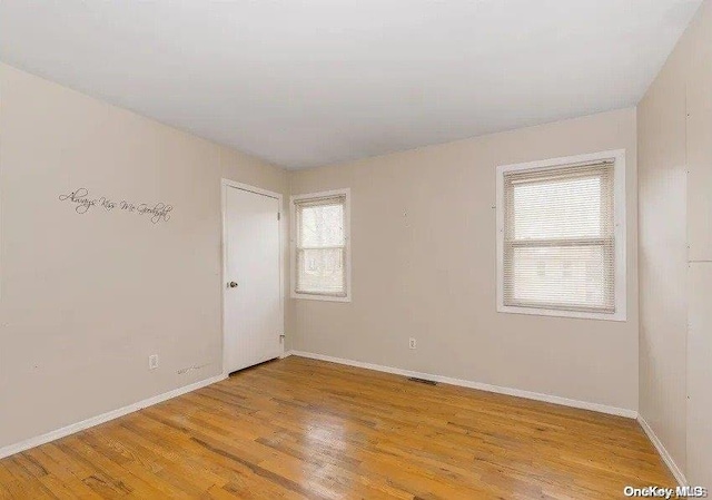 empty room with a healthy amount of sunlight and light wood-type flooring