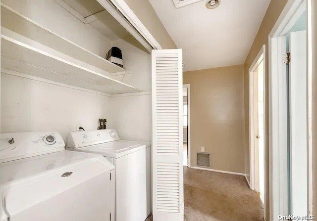 laundry area with washer and clothes dryer and carpet floors