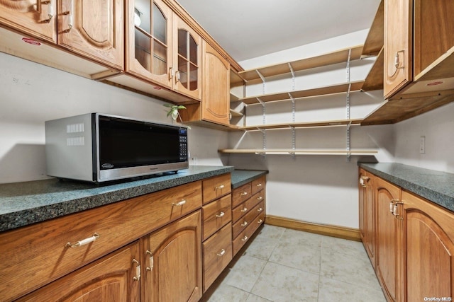 kitchen with light tile patterned flooring